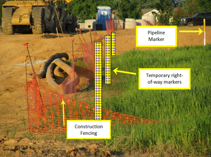 Temporary fence and markers are installed along the edges of the transmission pipeline right-of-way to alert construction crews.