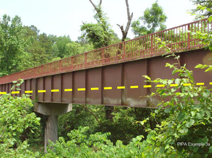 Aboveground transmission pipeline creek crossing was modified to accommodate a pedestrian bridge connecting walking trails. The transmission pipeline is located (illustrated) between the girders under the walkway. 