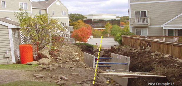 Example of impact of transmission pipeline maintenance on development built in close proximity to the edge of the pipeline right‐of-way. Structures adjacent to the ROW, such as the wooden fence, have been damaged as a result of the limited amount of workspace for large equipment. 